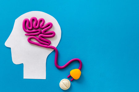 Brain charging and mental rest. Plug and cable leads to plastiline meanders on blue background top view copy spaceの写真素材