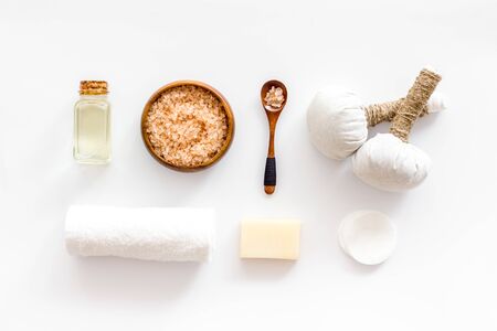 Spa set with massage herbal balls in wellness salon on white background top view patternの写真素材