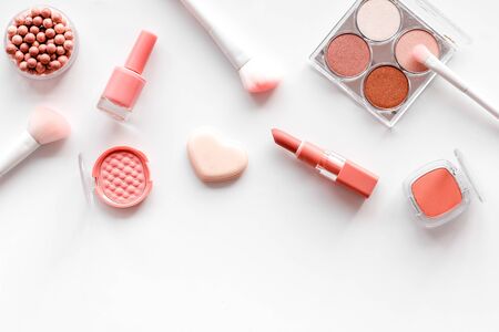 Makeup set with powder, rouge and brusheson white background top view patternの写真素材