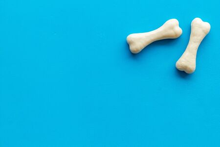 Treats for dogs. Chewing bones on blue background top view space for textの写真素材