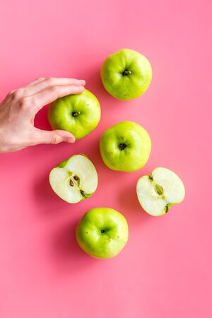 Autumn composition with green apple on pink background top view.の写真素材