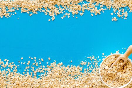 Oatmeals background on blue table top view.の写真素材
