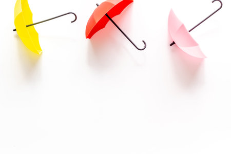 Rain concept. Umbrella on white background top view space for text pattern
