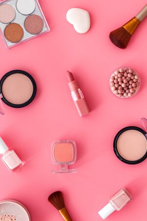 Makeup set with powder, rouge and brusheson pink background top view pattern.の写真素材