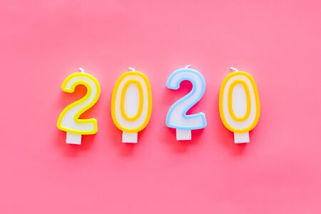 2020 New Year card. Candles on pink background top view.の写真素材