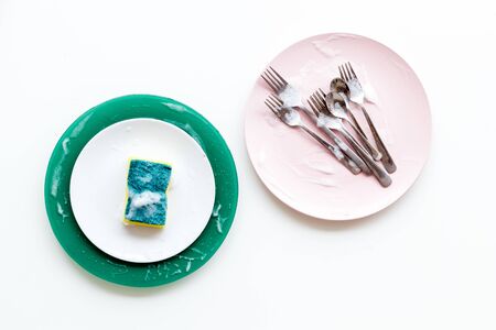 Washing dishes concept. Plates, spoons, forks on white background top viewの写真素材