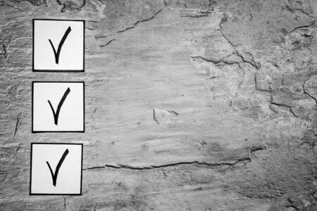 Check mark in check-box of check list on grey background top view.の写真素材