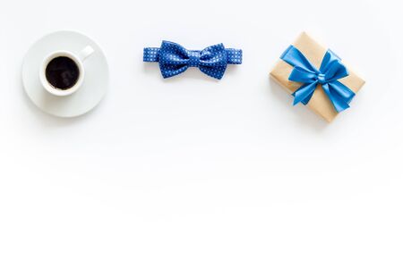 Greeting card for mens birthday. Present box, bow tie and coffee on white background top view frame copy spaceの写真素材