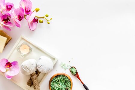 Preparing for massage in spa salon - with candles and orchids - white background top view frame copy spaceの写真素材