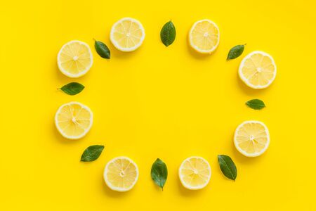 Lemon and leaves circle mockup on yellow background top view copy spaceの写真素材