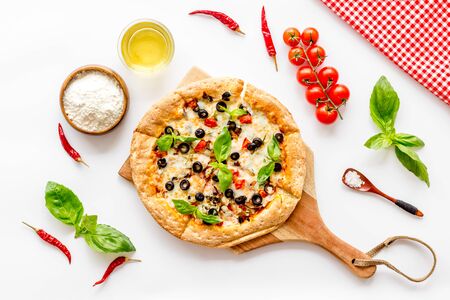 Pizza with tomato, basil, olives, cheese on white background top viewの写真素材