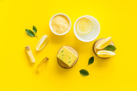 Lemon cosmetics. Cleansing tonic and handmade soap on yellow background top viewの写真素材