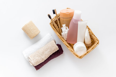 Bathroom accessories set with tooth brushes and towels on white background top view.