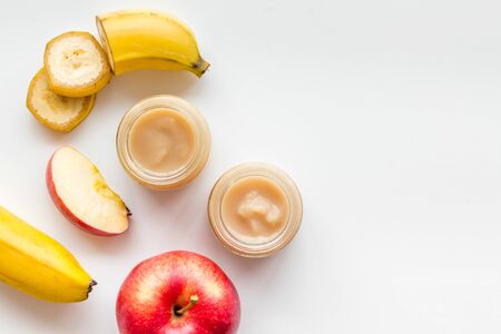 Fruity baby food with apple and banana on white background top view copy spaceの写真素材