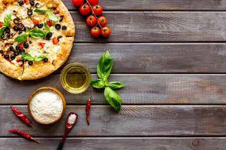 Traditional italian food: pizza on dark wooden background top view copy spaceの写真素材