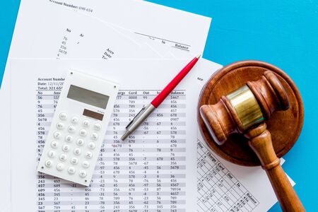 Arrest bank account concept. Judge hammer near financial documents on blue  top viewの写真素材