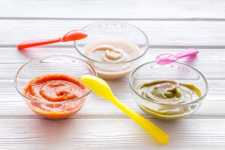 Vegetable and fruits puree for feed babies on white wooden background.の写真素材