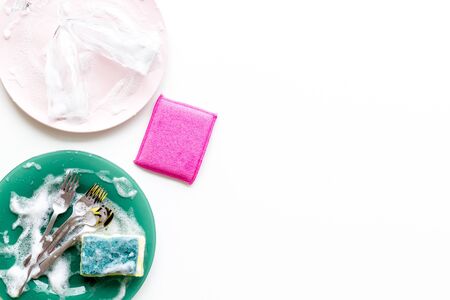 Washing dishes frame with plates, sponges, foam on white background top view copy spaceの写真素材