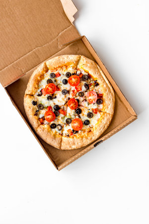 Order pizza to home or office. Italian food in box on white background top view.の写真素材