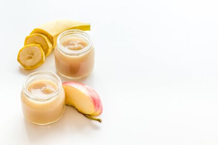 Fruity baby food with apple and banana on white background space for textの写真素材