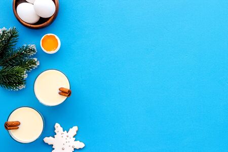 Make festive drink eggnog - ingredients on blue background top view frame copy spaceの写真素材