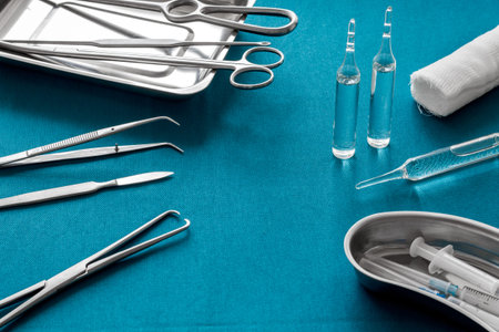 Plastic surgery instruments and tools with bandage and ampoulie on blue background.