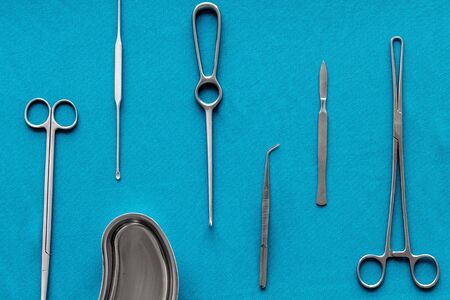 Plastic surgery. Instruments for beauty operations on blue background top view.の写真素材