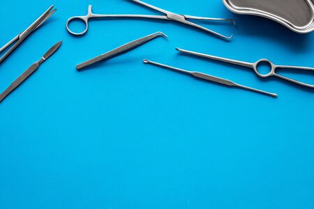Plastic surgery. Instruments for beauty operations on blue background top view.の写真素材