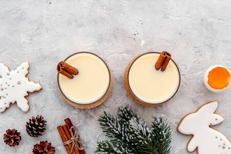 Drink eggnog on grey New Year table decorated with spruce branches and gingerbread top view.の写真素材