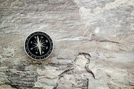 Compass - small and stylish - on grey background top view.の写真素材