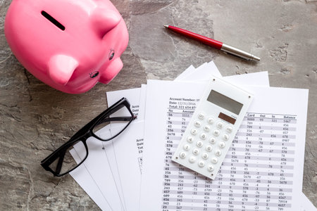 Taxes payment concept. Financial documents, piggy bank, calculator on grey background top view.