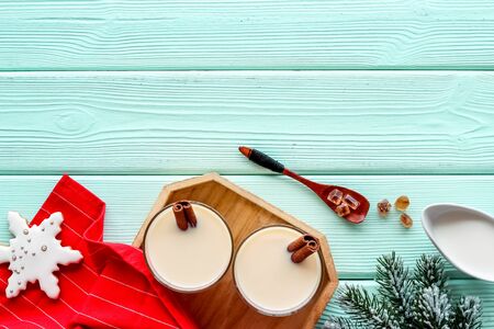 Make festive drink eggnog - ingredients on green wooden background top view frame copy spaceの写真素材