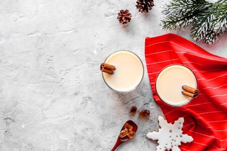 Drink eggnog on grey New Year table decorated with spruce branches and gingerbread top view frame copy spaceの写真素材