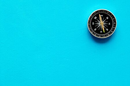 Compass - small and stylish - on blue background top view copy spaceの写真素材