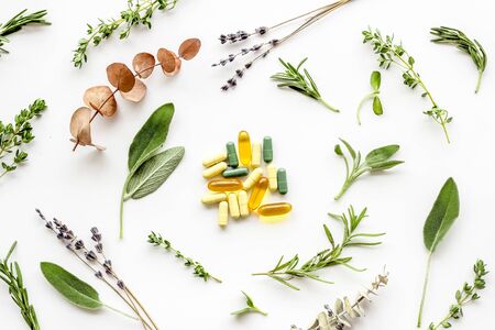 Medicine made from wildflowers and herbs with essential oils on white background top view patternの写真素材