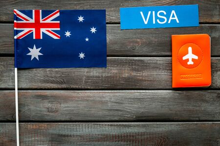 English or Great Britain flag near passport on dark wooden background top view.の写真素材