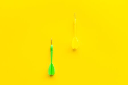 Plastic dart or arrows for darts game on yellow background top view.の写真素材
