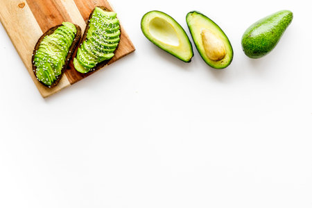 Healthy food. Avocado toast on white background top view frame copy space