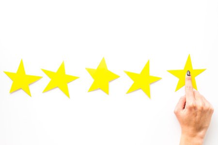 Positive feedback, good service concept. Hand touch the best star on white