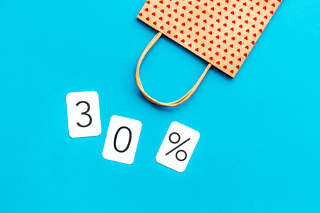 30 off discount sale concept with shopping paper bag on blue