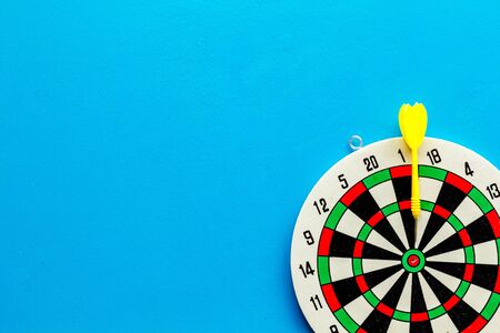 Goal achievement concept. Dartboard and arrows or dart on blue background top view.の写真素材