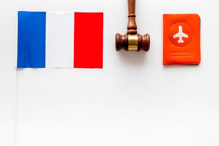 Visa to France concept. French flag near passport and hammer on whiteの写真素材