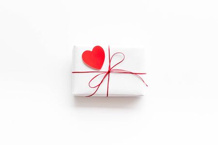 Valentine's Day gift. Present box near paper hearts on white background top-down.の写真素材