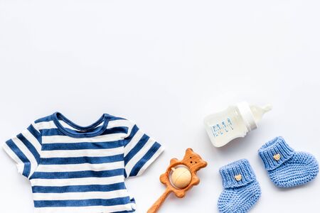 Baby background. Clothes and accessories for newborn boy on white table top-down.の写真素材