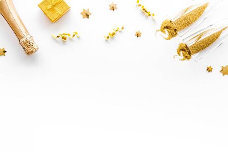 New Year card with champagne glasses - gold color - on white background frame.の写真素材