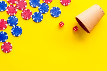 Poker frame. Chips and dices on yellow background top-down.の写真素材