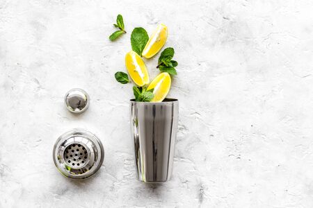 Bar background. Making cocktails concept. Shaker, lime on grey background top-down copy spaceの写真素材