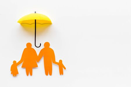 Family cutout under umbrella on white background top-down copy spaceの写真素材