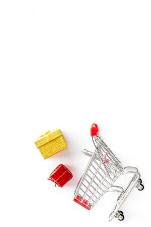 Gifts shopping. Present boxes and cart on white background top-down.の写真素材