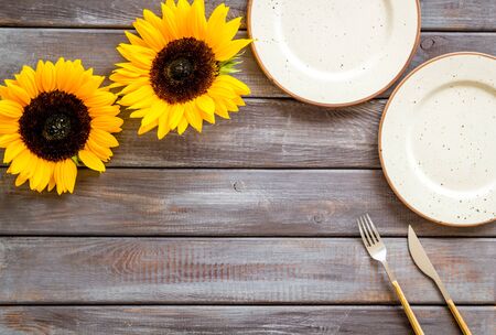 Dinning table decorated with sunflower, dark wooden background top-down copy spaceの写真素材